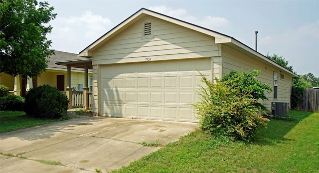 ranch-style house with a garage, a front lawn, and central AC unit