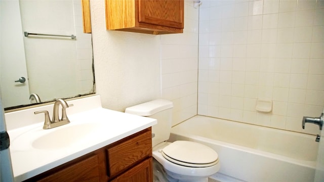 full bathroom with tiled shower / bath, vanity, and toilet