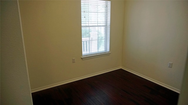 empty room featuring dark hardwood / wood-style flooring