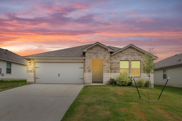 view of front of home with a yard and a garage