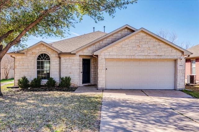 ranch-style home with central air condition unit and a garage