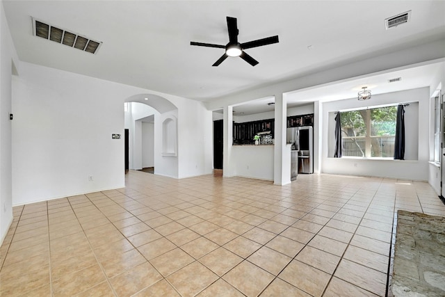 unfurnished living room featuring ceiling fan and light tile floors