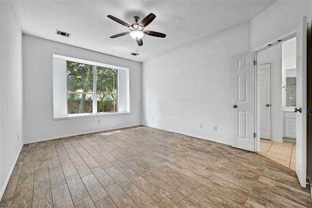 unfurnished room featuring ceiling fan and light hardwood / wood-style flooring