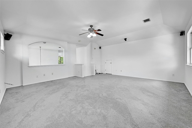 carpeted spare room with lofted ceiling and ceiling fan