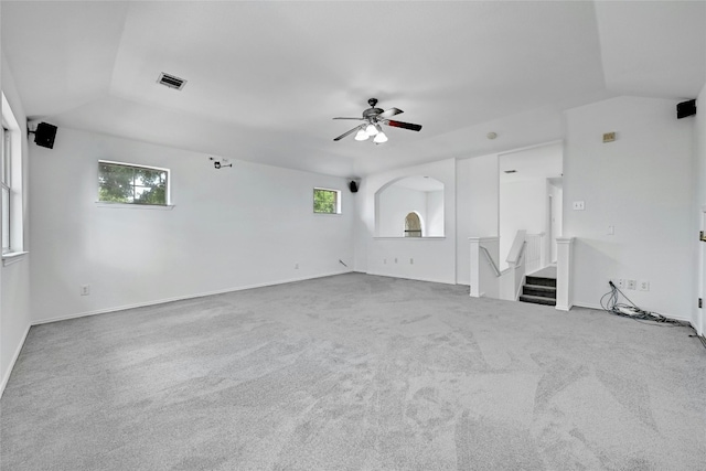 carpeted spare room featuring lofted ceiling and ceiling fan