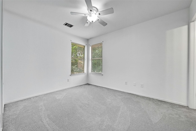 carpeted spare room with ceiling fan