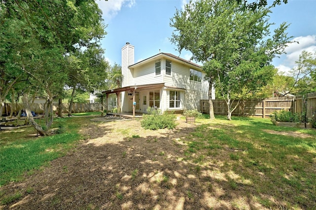 back of house featuring a yard