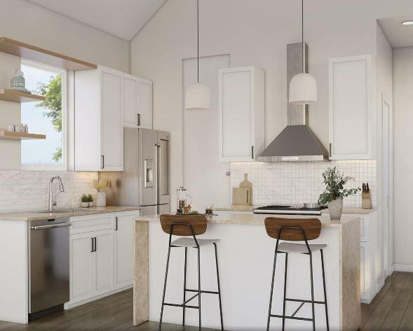 kitchen featuring white cabinets, backsplash, pendant lighting, a kitchen island, and appliances with stainless steel finishes