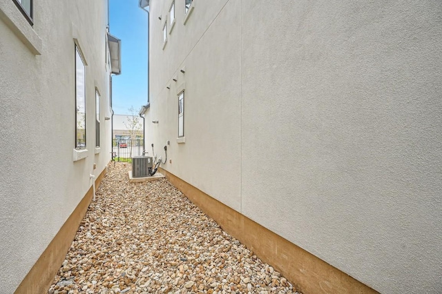 view of side of home featuring cooling unit