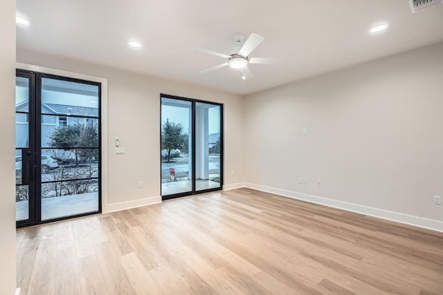 empty room featuring ceiling fan and light hardwood / wood-style flooring