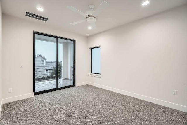 carpeted spare room featuring ceiling fan