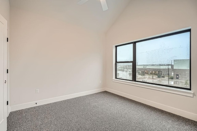 carpeted empty room with vaulted ceiling and ceiling fan