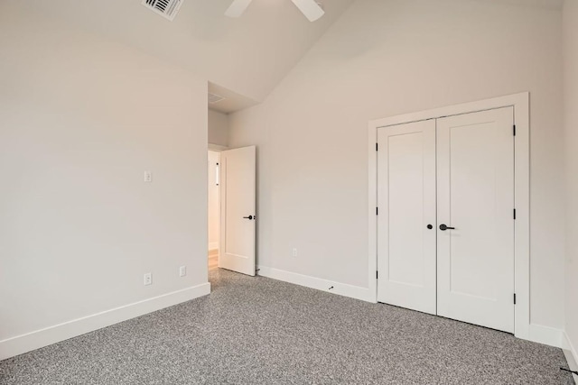 unfurnished bedroom with ceiling fan, high vaulted ceiling, and a closet