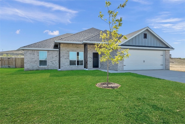 view of front of house with a garage and a front lawn