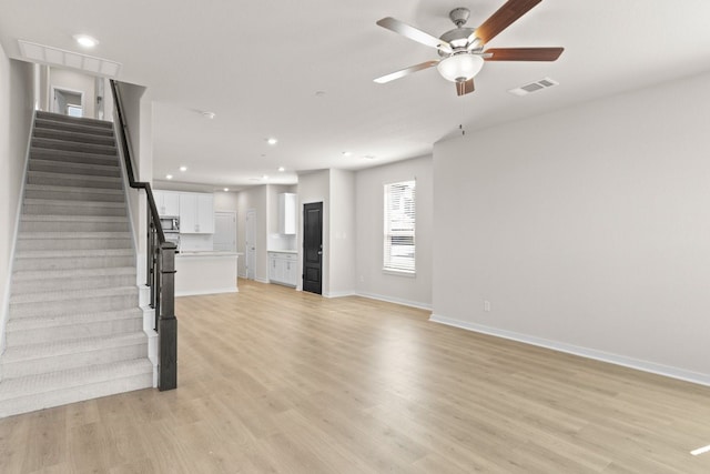 unfurnished living room with light hardwood / wood-style floors and ceiling fan