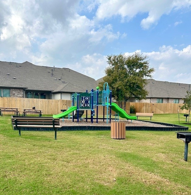 view of playground with a lawn