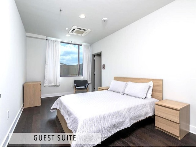 bedroom with dark wood-type flooring