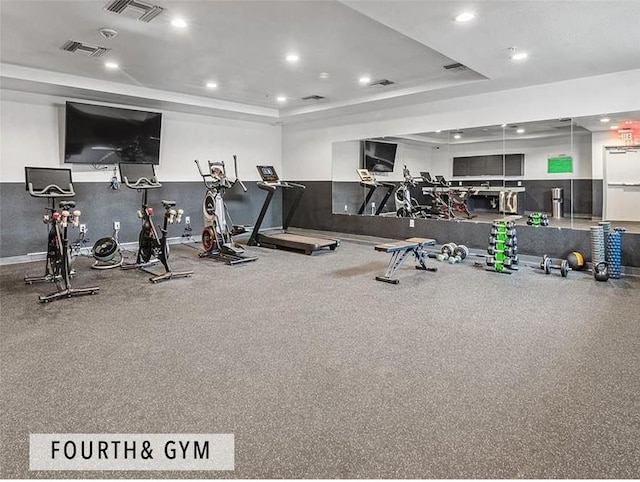 gym featuring a raised ceiling