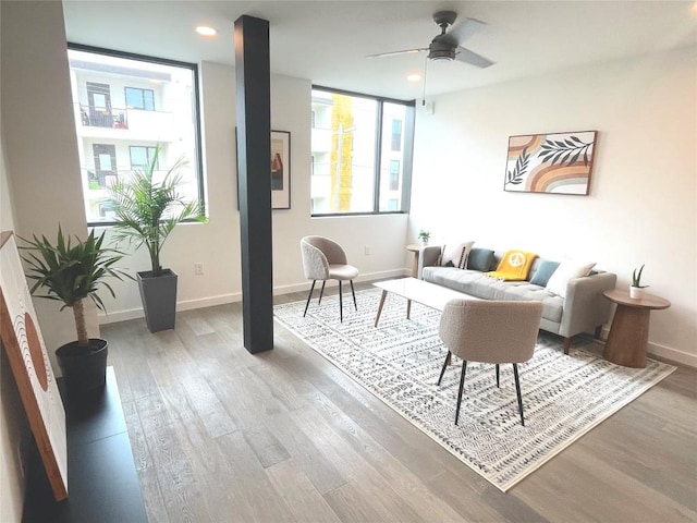 living room featuring light wood-type flooring and ceiling fan