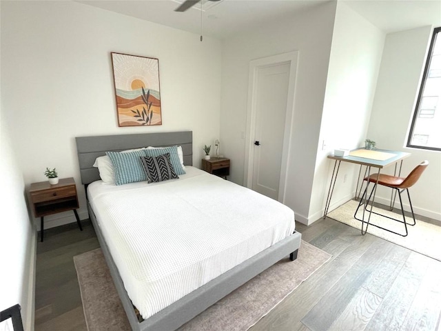 bedroom with ceiling fan and wood-type flooring