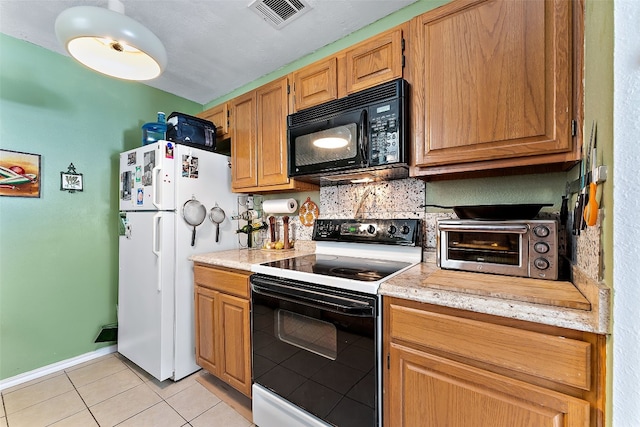 kitchen featuring light stone counters, white appliances, and light tile patterned floors