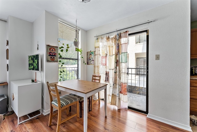 dining area featuring a wealth of natural light and wood-type flooring