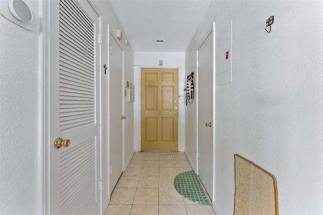 corridor featuring light tile patterned floors