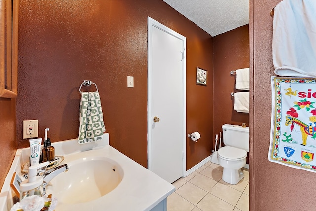 bathroom featuring tile patterned floors, toilet, sink, and a textured ceiling