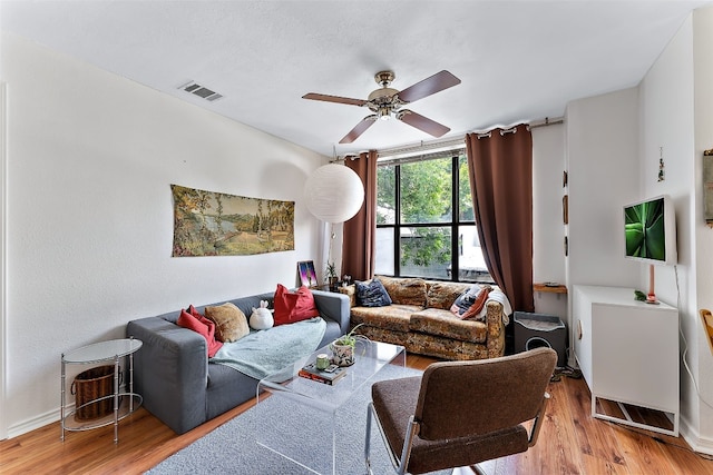 living room featuring ceiling fan and light hardwood / wood-style flooring