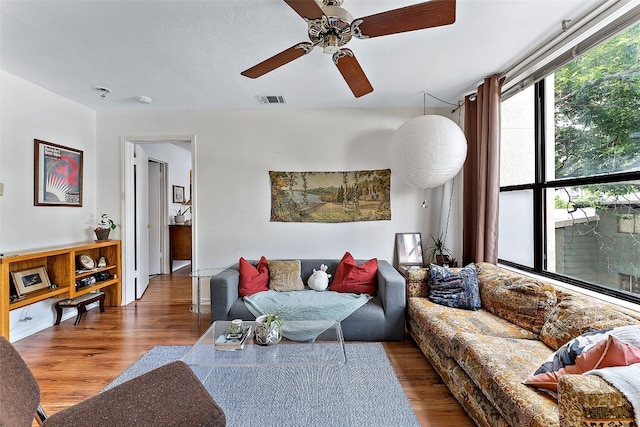 living room featuring ceiling fan and hardwood / wood-style floors