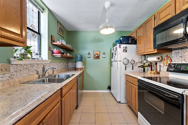 kitchen featuring white appliances, sink, and light tile patterned floors