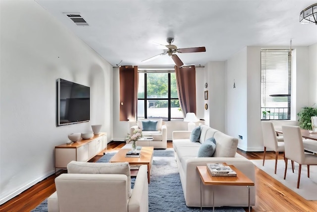 living room with ceiling fan and light wood-type flooring