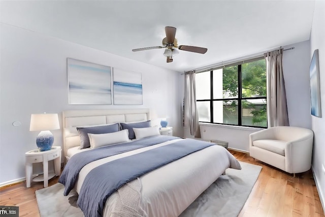 bedroom with ceiling fan and light wood-type flooring