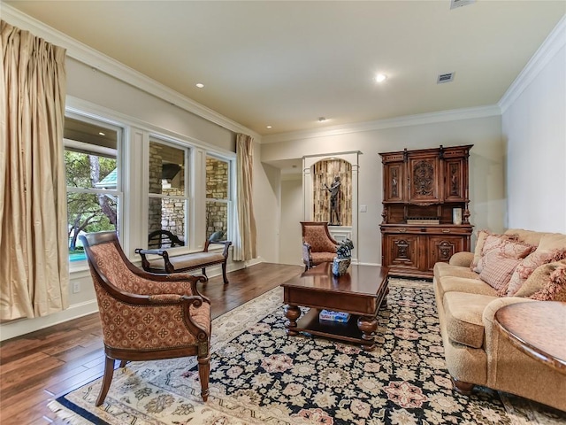 living room featuring dark hardwood / wood-style floors and crown molding