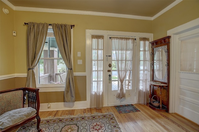 entryway with french doors, ornamental molding, and light hardwood / wood-style floors