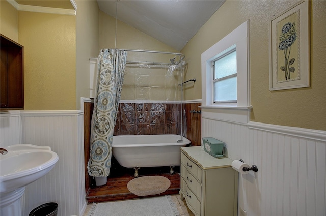 bathroom featuring vaulted ceiling, sink, and shower / bathtub combination with curtain