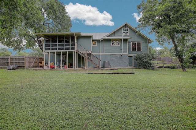 back of house with a lawn, central AC unit, and a sunroom