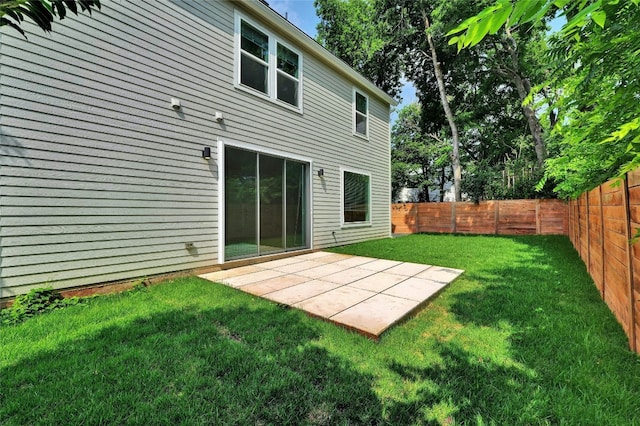 back of house with a patio area, a yard, and a fenced backyard