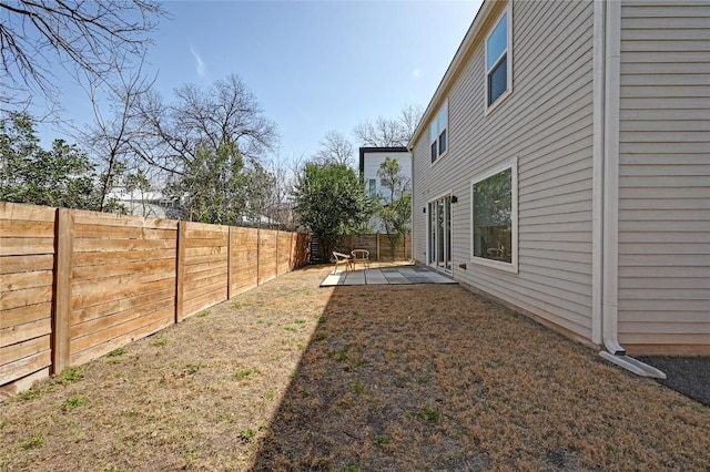 view of yard featuring a patio area and a fenced backyard