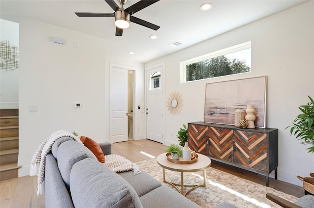 living area with light wood-type flooring, visible vents, a ceiling fan, and recessed lighting