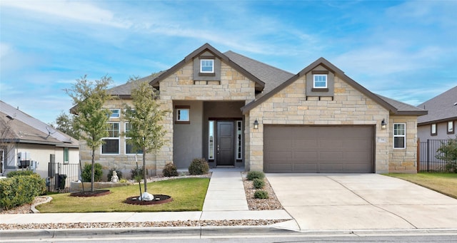 view of front of house featuring a front lawn and a garage