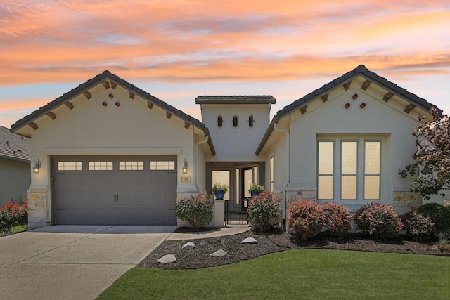 mediterranean / spanish-style house featuring a garage and a yard