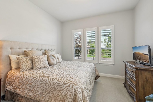 carpeted bedroom with lofted ceiling