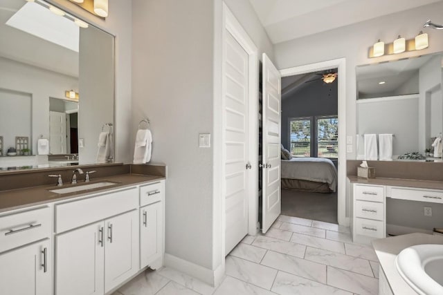 bathroom with vanity, ceiling fan, and lofted ceiling