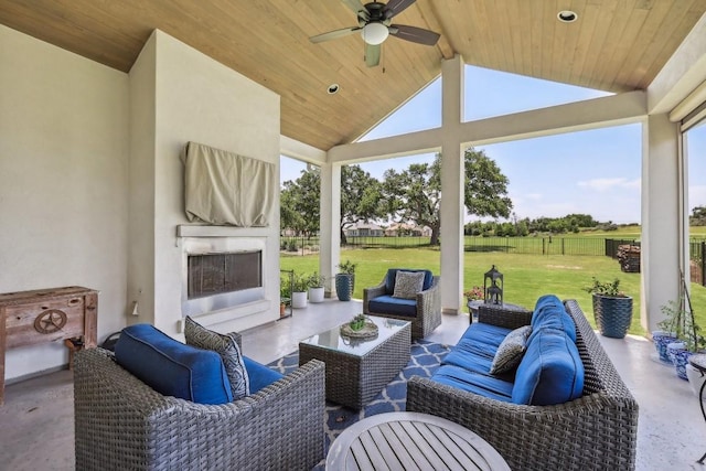 view of patio with an outdoor living space with a fireplace and ceiling fan