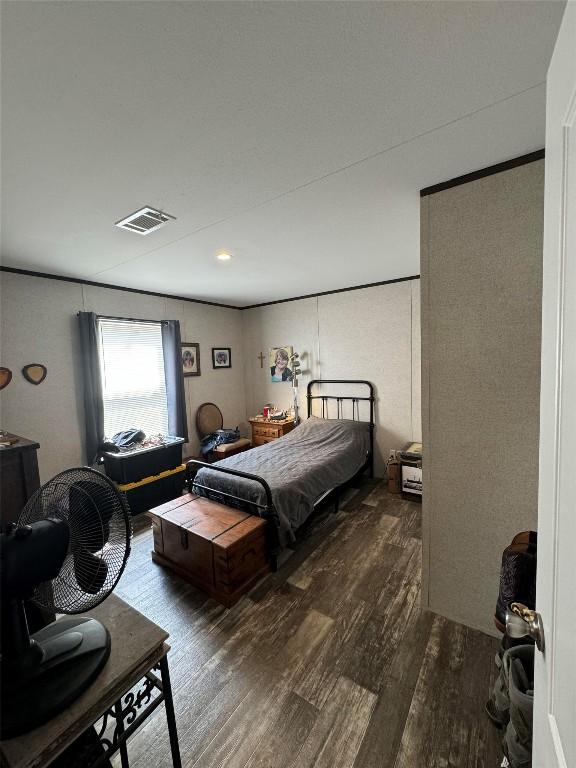 bedroom with dark wood-type flooring