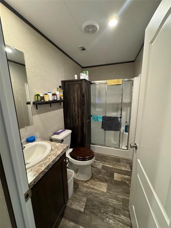 bathroom with vanity, wood-type flooring, and toilet