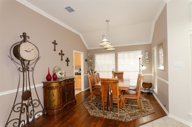 dining area featuring ornamental molding, lofted ceiling, and wood-type flooring