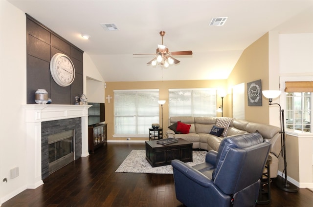 living room with ceiling fan, dark hardwood / wood-style flooring, a fireplace, and vaulted ceiling