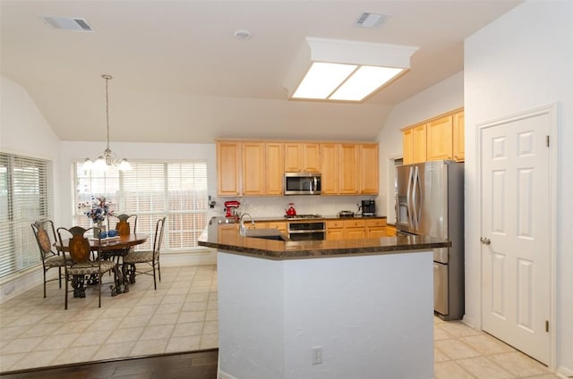 kitchen featuring appliances with stainless steel finishes, pendant lighting, light brown cabinetry, lofted ceiling, and an inviting chandelier